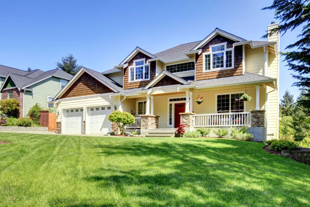 Two-story single-family home with a front porch and attached garage